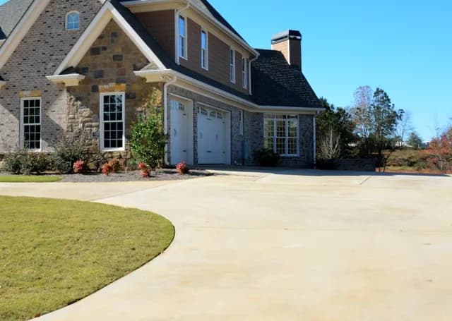 Brick house with a clean concrete driveway