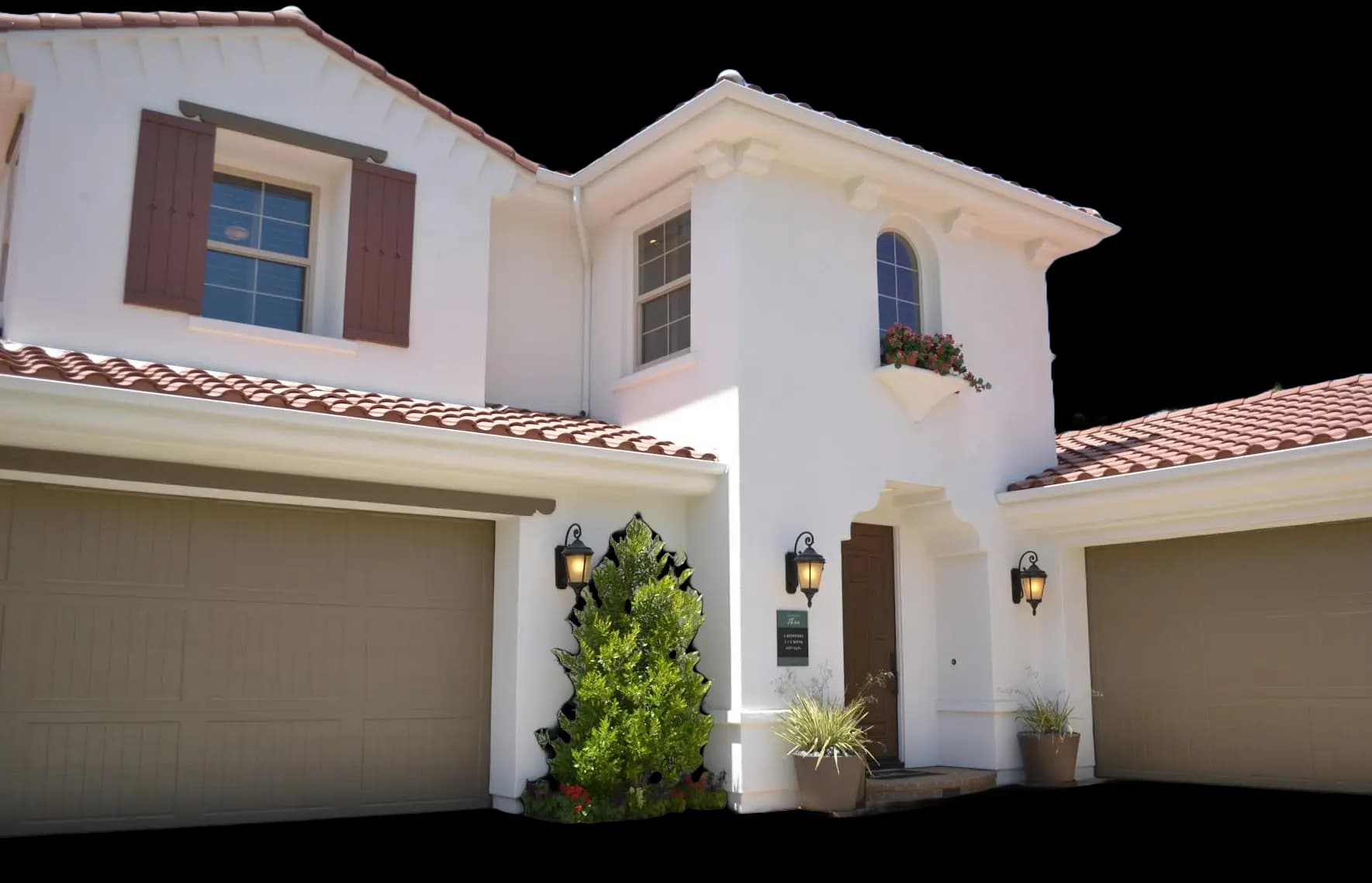 Two-storey stucco home with a tile roof and two garages